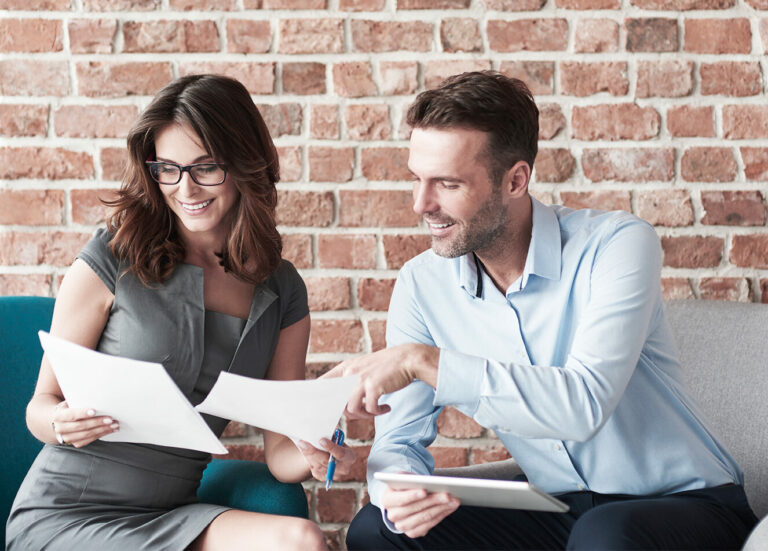 Two production accountants working together on a film budget.